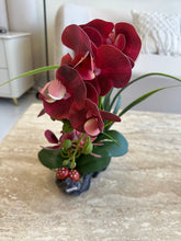 Maroon orchids flower arrangement